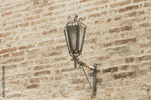Medieval lantern on the brick wall (Marche, Italy, Europe)