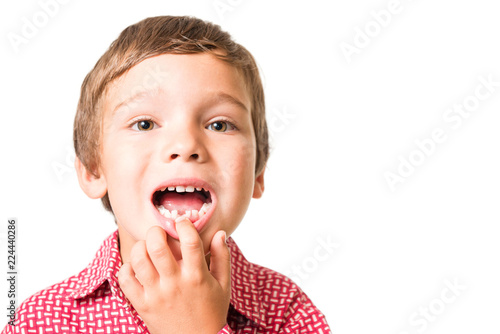 young adorable boy with open mouth, milk-tooth missing, isolated on white background