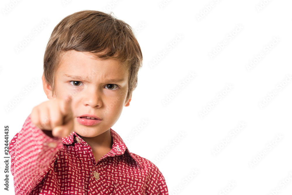 young adorable boy pointing with finger towards you, focus on face, isolated on white background young adorable boy pointing with finger towards you, focus on face, isolated on white background