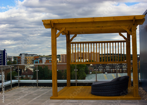 Wallpaper Mural wooden gazebo made of wood on the roof with an armchair Torontodigital.ca
