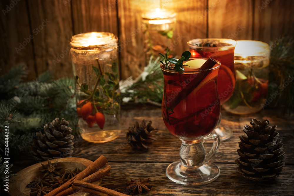 Christmas mulled wine with spices on rustic wooden background