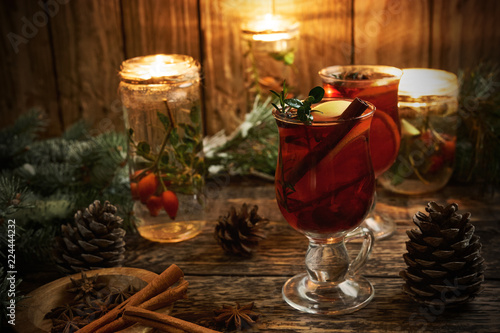 Christmas mulled wine with spices on rustic wooden background