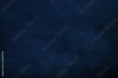 DArk blue  grungy canvas background or texture with dark vignette borders