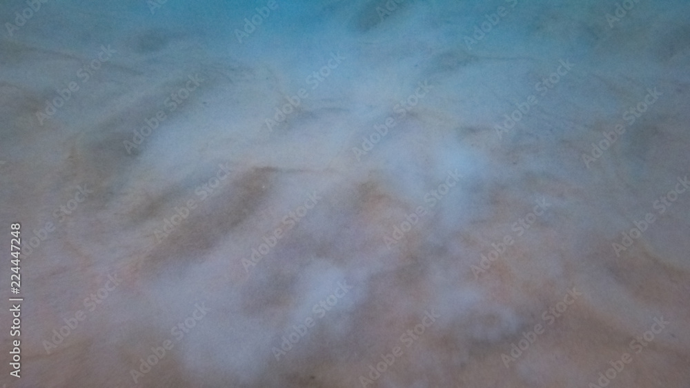 Looking at the Sands of the Shallow Ocean Floor in Phuket Thailand