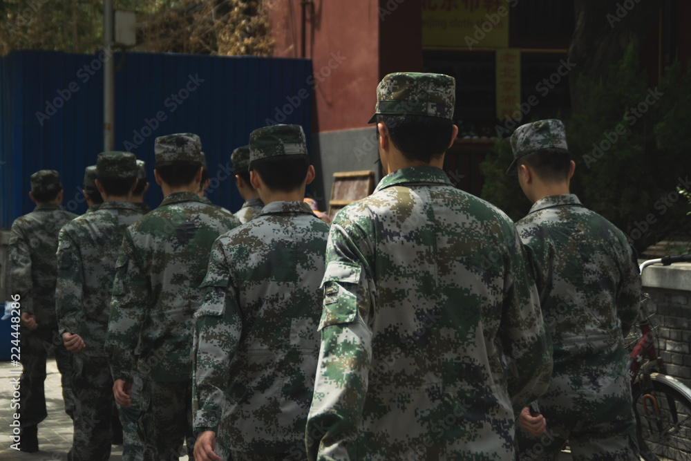 Fototapeta premium Chinese soldiers with there uniforms walking on a street of Beijing