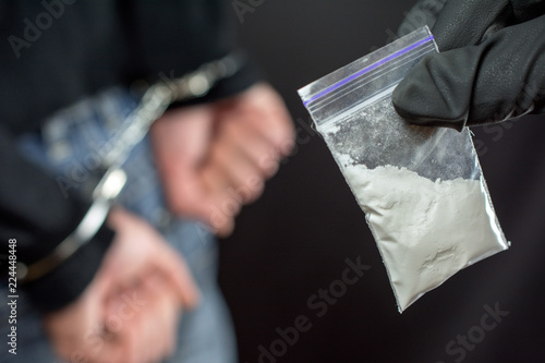 Police arrest drug trafficker with handcuffs Fototapet