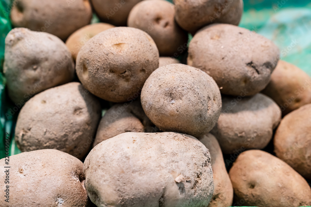 Potatos are vegetable that has rich in vitamins and starch. They are displaying on stall to sell to somebody, and looks very fresh.