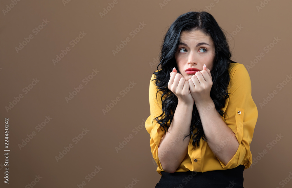 Worried young woman on a solid background Worried young woman on a solid background