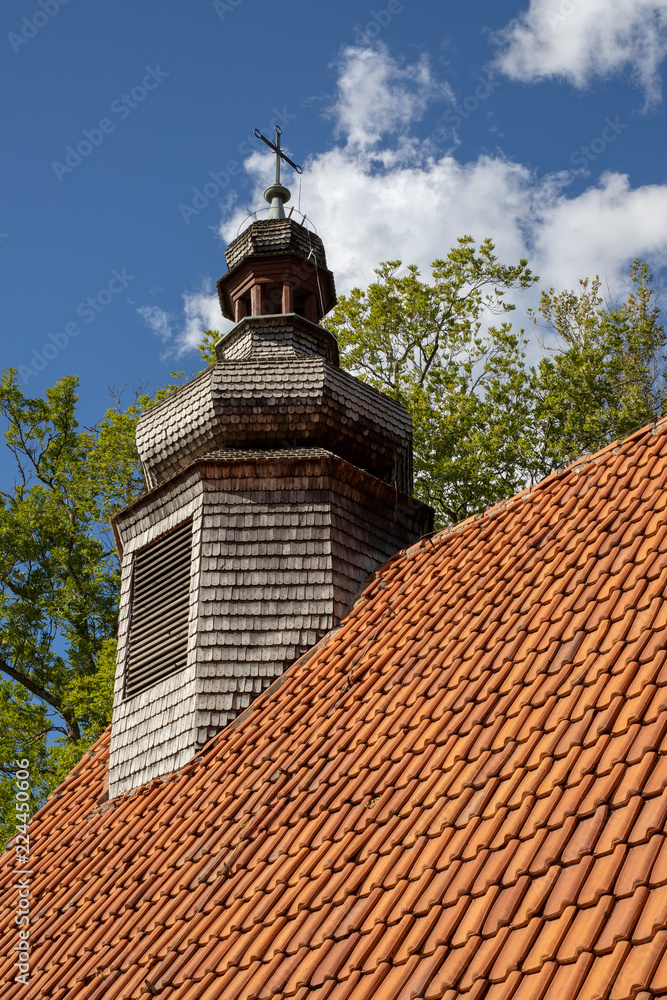 Old chapel with a wooden tower. A red brick church in Central Europe.