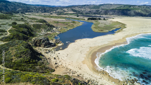 An aerial drone view over Tunquen Beach in Valparaiso region and close to Algarrobo, an awesome beach with a lot of wildlife because of it wetlands and turquoise waters, an idyllic travel destination