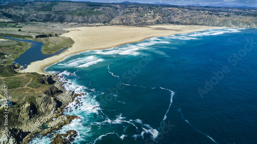 An aerial drone view over Tunquen Beach in Valparaiso region and close to Algarrobo, an awesome beach with a lot of wildlife because of it wetlands and turquoise waters, an idyllic travel destination © abriendomundo