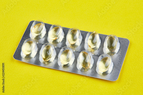 Sealed package with transparent capsules on yellow background