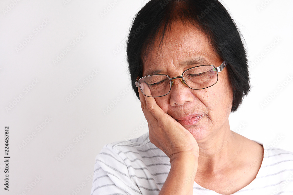 Older Asian women are sad because of toothache. Older Asian women are sad because of toothache.