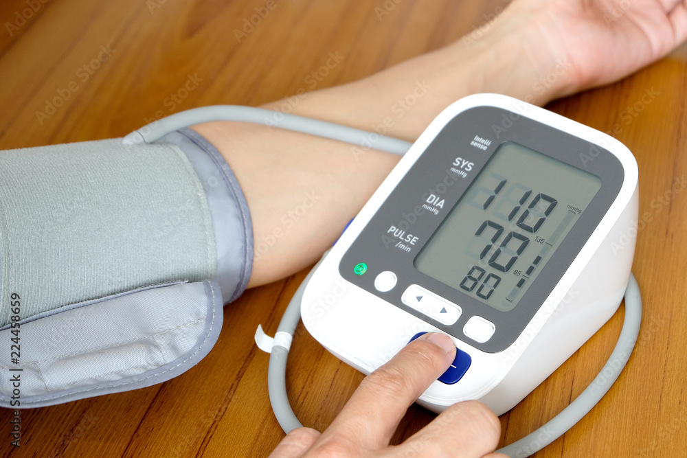 Human check blood pressure monitor and heart rate monitor with digital pressure gauge. Health care and Medical concept Human check blood pressure monitor and heart rate monitor with digital pressure gauge. Health care and Medical concept