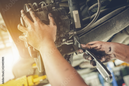  Mechanic repairing a car with replace brake disc and pads