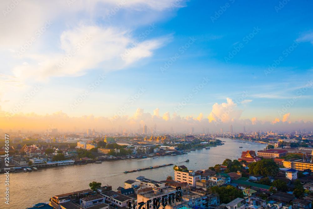 Sun rise The Chao Phraya River Behind the view of the royal palace in the corner.