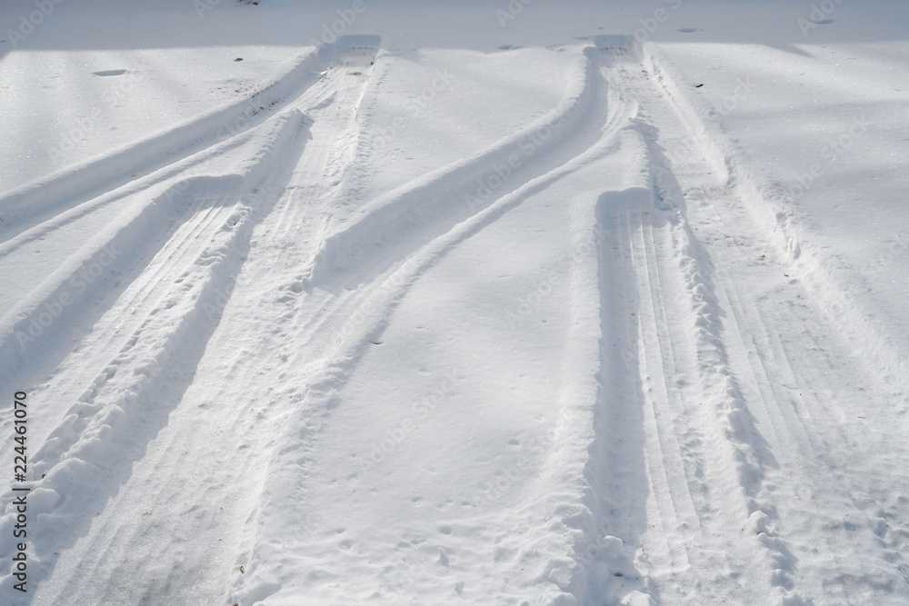 tire tracks in the snow at the parking area