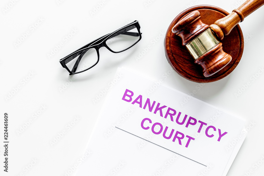 Title of documents the bankruptcy court near judge gavel on white background top view copy space