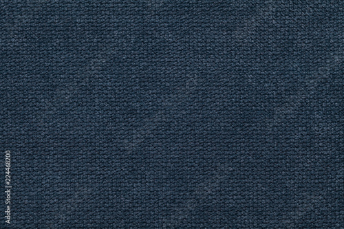 Dark blue fluffy background of soft, fleecy cloth. Texture of light nappy textile, closeup.