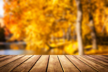 Wooden table top on blur autumn background