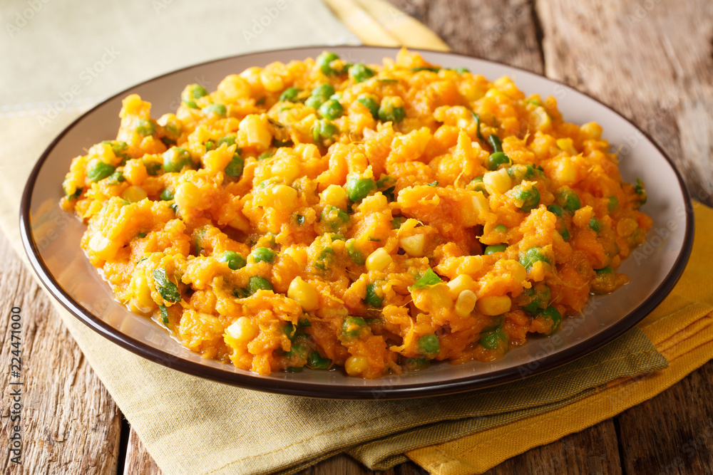 Delicious African food Irio spicy puree of sweet potato with green peas and corn close-up on a plate. horizontal Delicious African food Irio spicy puree of sweet potato with green peas and corn close-up on a plate. horizontal