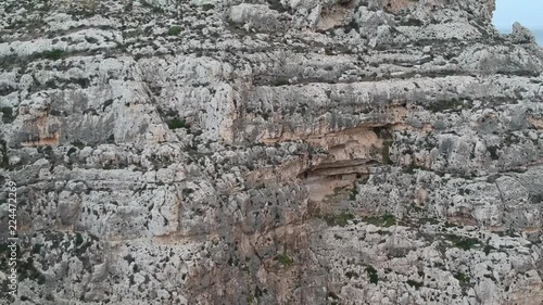 Upwards revealing shot of a cliff near blue groto in Malta photo