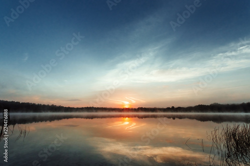 Fog over the lake, twilight over the lake, very dense fog, dawn, blue sky over the lake, the morning comes, the forest reflects in the water, surface water, clear morning sky, gothic, Grim picture