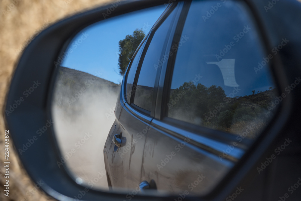 Rear view on a dusty road