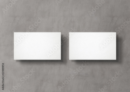 White business card stack on concrete desk 3D rendering