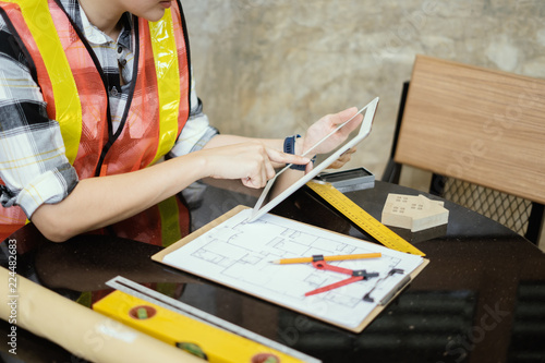 architect woman working with tablets laptop and blueprints,engineer inspection in workplace for architectural plan,sketching a construction project ,Business concept