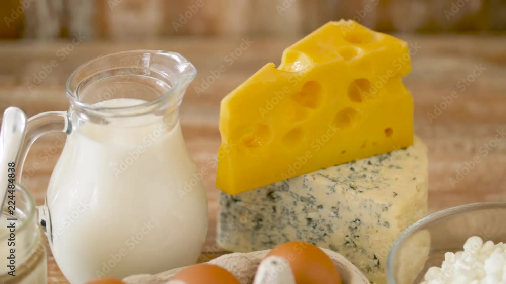 food, culinary and cooking concept - close up of natural chicken eggs, farm milk, sour cream and homemade cottage cheese on wooden table food, culinary and cooking concept - close up of natural chicken eggs, farm milk, sour cream and homemade cottage cheese on wooden table