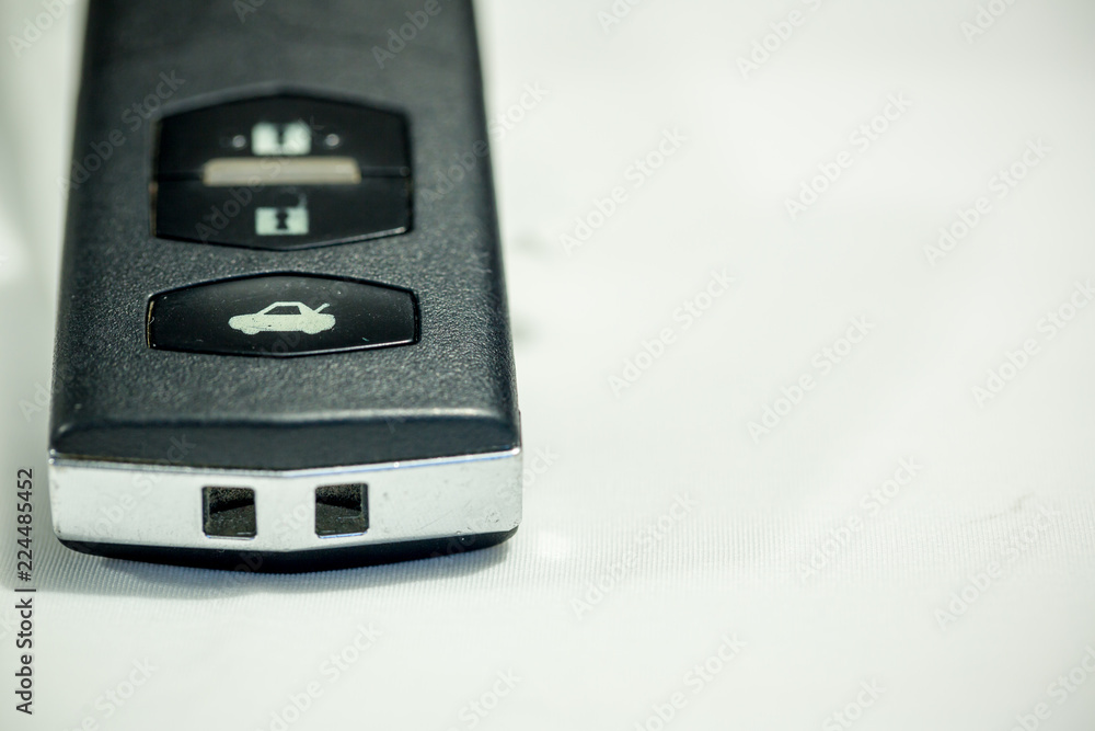 Old car key with remote control on white background, safety lock technology. Old car key with remote control on white background, safety lock technology.