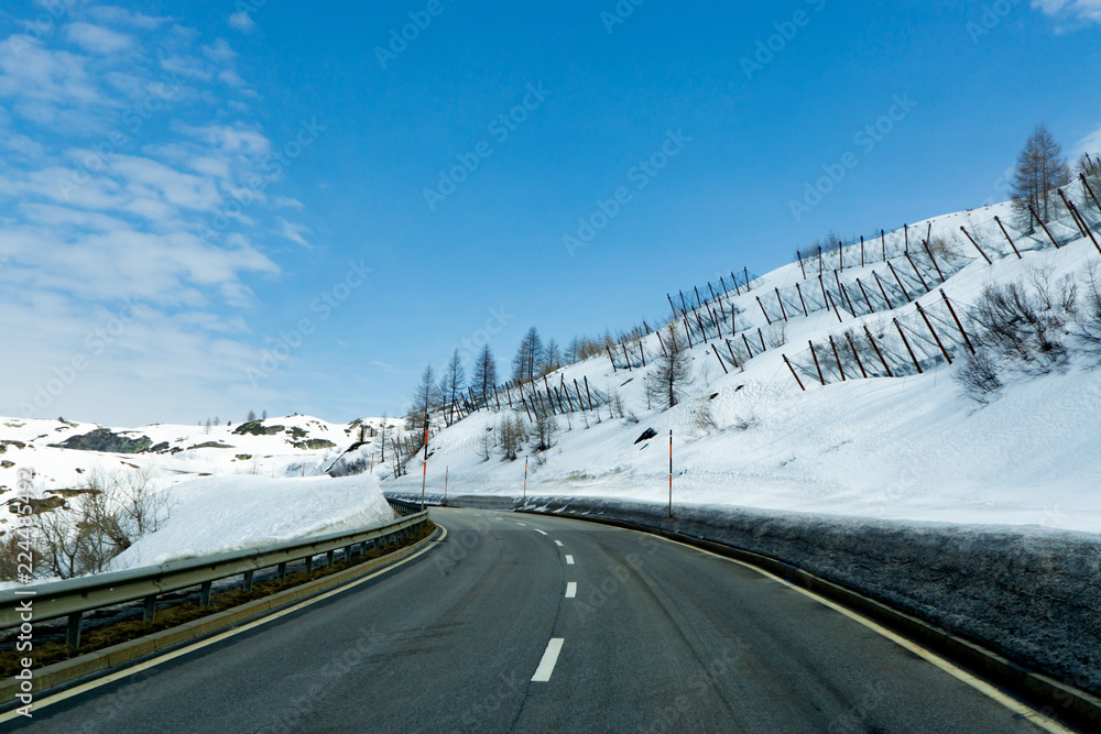 Winter landscape of swiss Alps and a mountain Winter road and trees covered with snow, Switzerland
