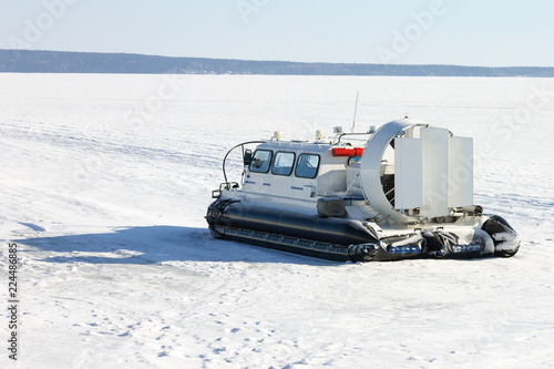 Hovercraft on ice of frozen lake in winter