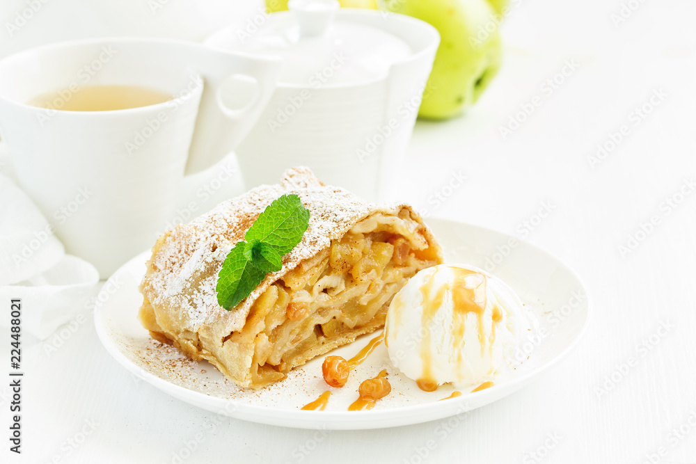 apple strudel with cinnamon and an ice cream ball.