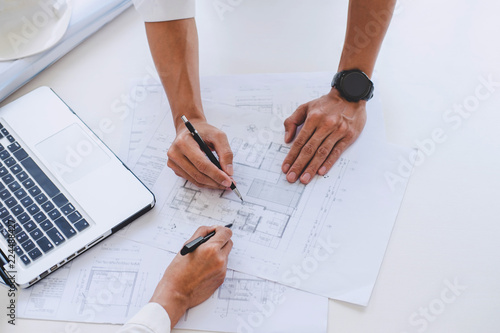 Architect or Engineer meeting working with partner on blueprint for architectural project in progress, construction and structure concept