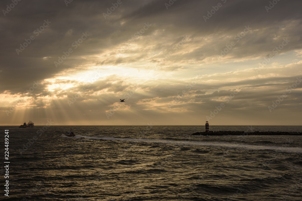 Sea sun ray and Light house in the eve