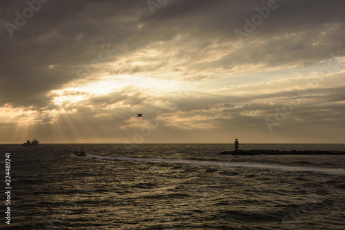 Sea sun ray and Light house in the eve