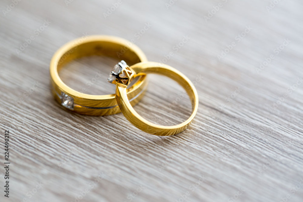 Diamond ring, wedding ring, Wedding Ring bride price. Wedding symbols. Wedding ceremony. image for objects and article.rings on wooden surface, symbol of couple Diamond ring, wedding ring, Wedding Ring bride price. Wedding symbols. Wedding ceremony. image for objects and article.rings on wooden surface, symbol of couple