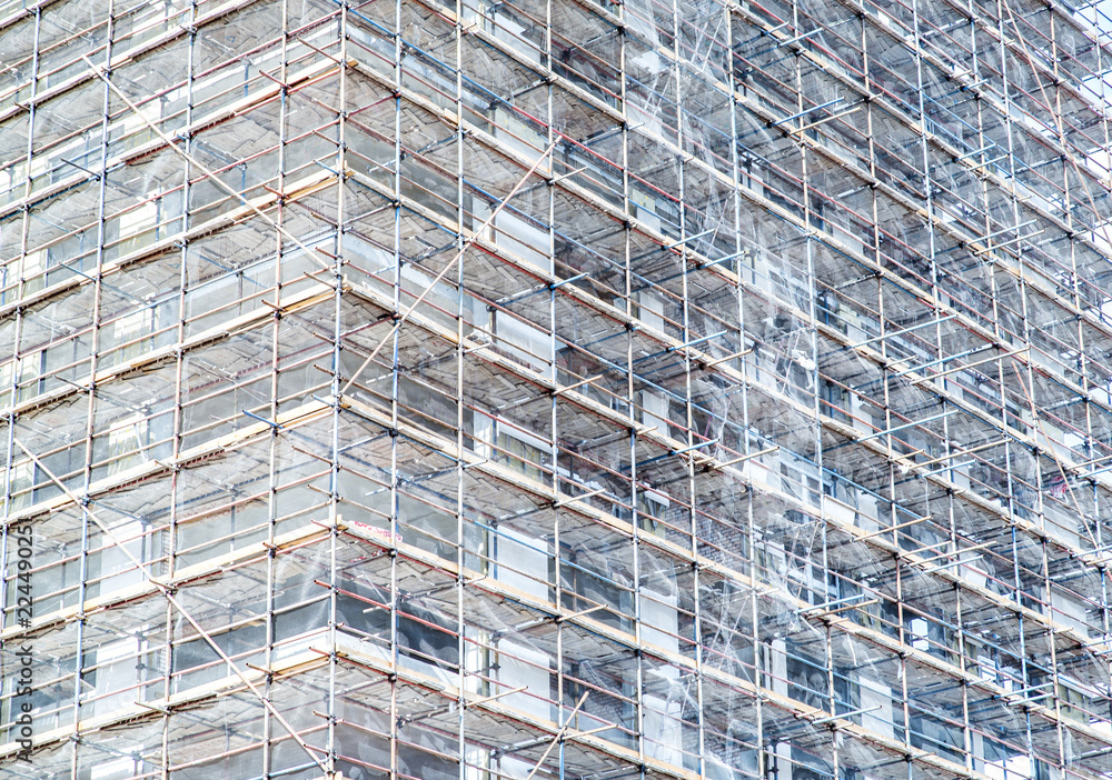 Building apartments under construction on a sunny day. Monochrome toning. Building apartments under construction on a sunny day. Monochrome toning.