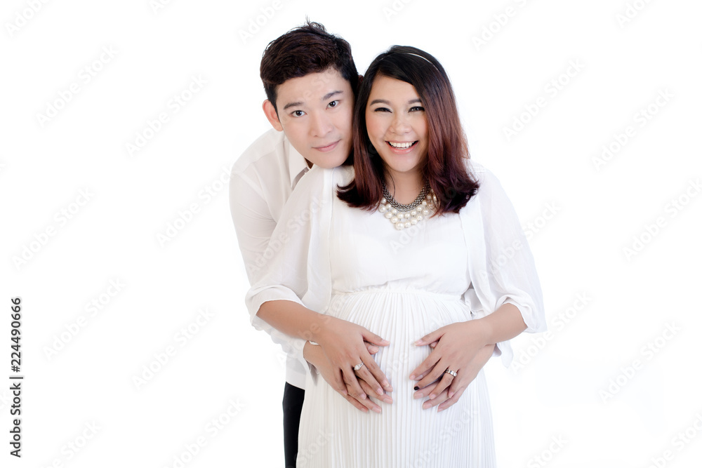 Man embracing her pregnant woman from behind over white background Man embracing her pregnant woman from behind over white background