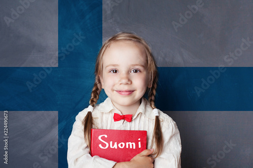 Learning finnish language. Smart child girl on the Finnish flag background