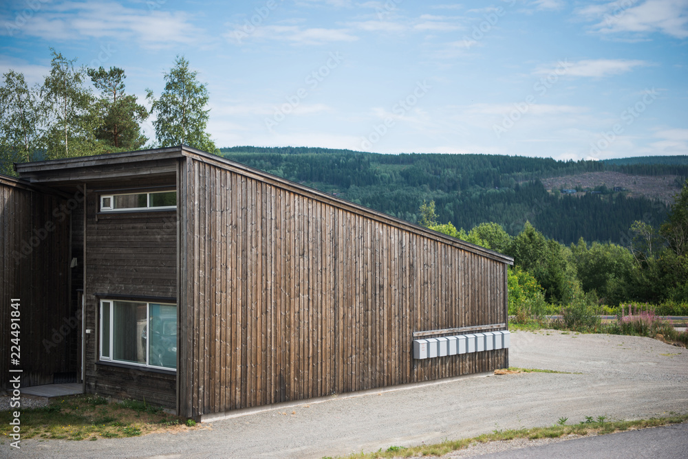 wooden building with green mountain on background, Trysil, Norway's largest ski resort wooden building with green mountain on background, Trysil, Norway's largest ski resort