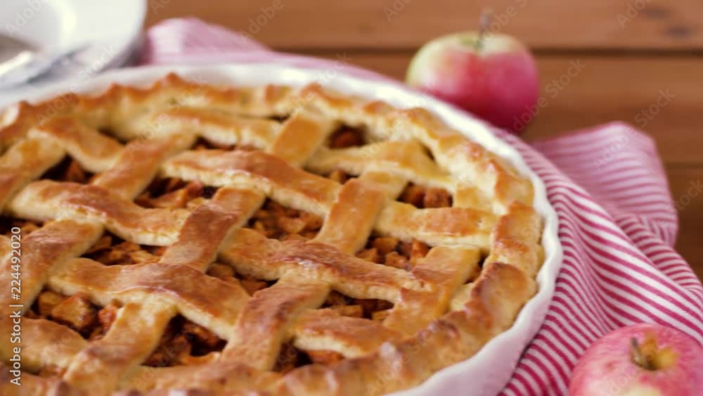 food, culinary and baking concept - close up of apple pie and knife on wooden table food, culinary and baking concept - close up of apple pie and knife on wooden table