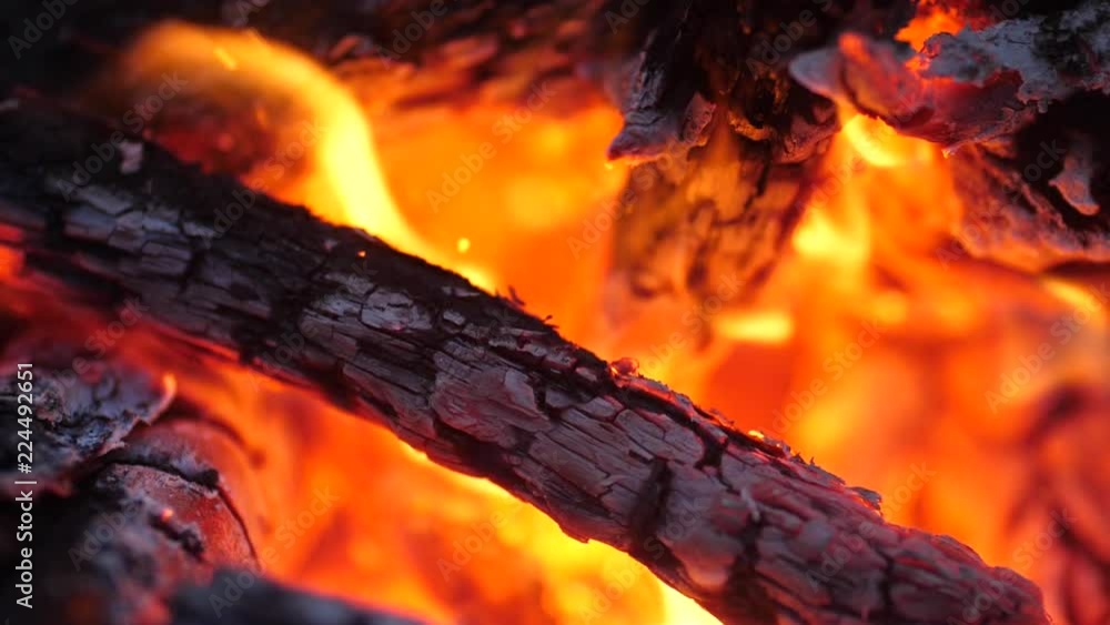 Burning red coals of the bonfire. Campfire. Tongue of flame. Sparks flying from the fire. Slow motion, 180fps. Burning red coals of the bonfire. Campfire. Tongue of flame. Sparks flying from the fire. Slow motion, 180fps.