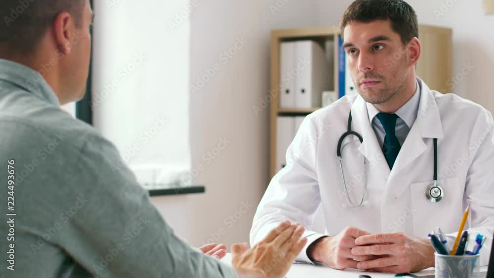 medicine, healthcare and people concept - doctor and male patient having health problem meeting at hospital medicine, healthcare and people concept - doctor and male patient having health problem meeting at hospital
