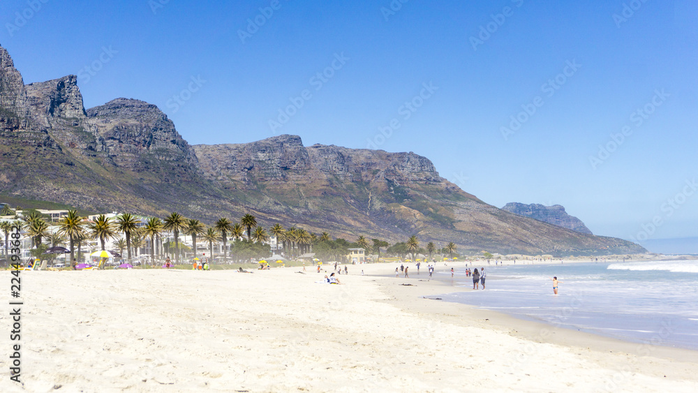 Naklejka premium People and city at Camps Bay beach, Cape Town, South Africa
