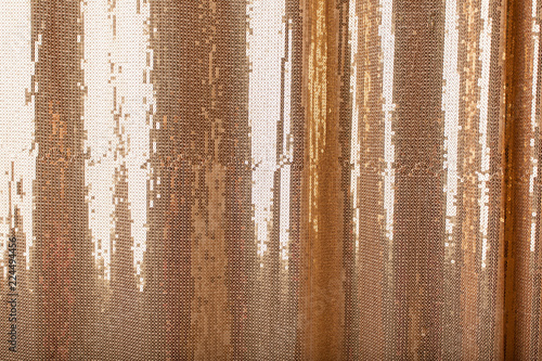 Background of golden bright sparkles on the fabric