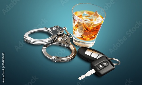 Fotografie Whiskey with car keys and handcuffs concept for drinking and