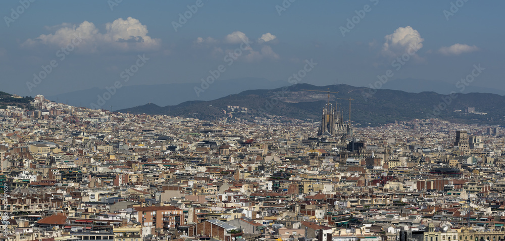 City of Barcelona with towering over famous church Sagrada Familia